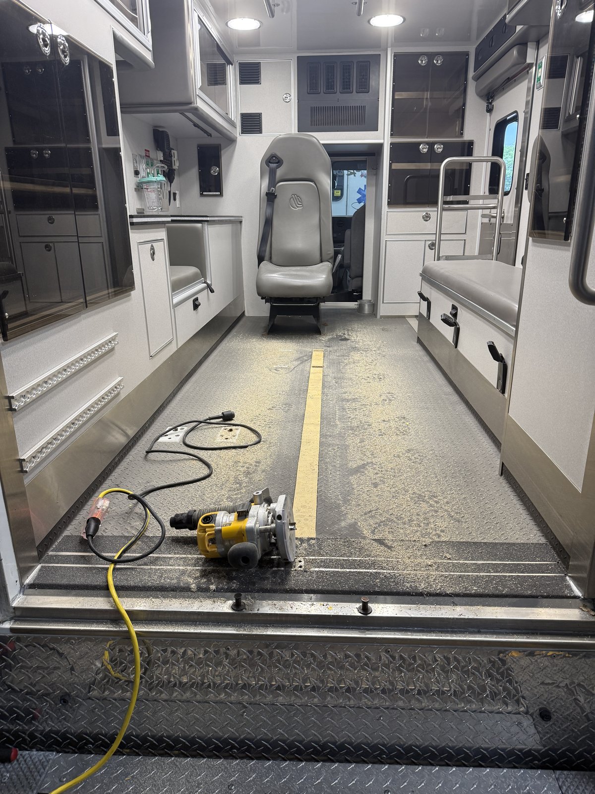 Ambulance patient module interior during an on-site floor and equipment service